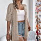 Gilet cardigan à manches courtes et motifs ajourés tricoté pour femme