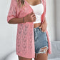 Gilet cardigan à manches courtes et motifs ajourés tricoté pour femme
